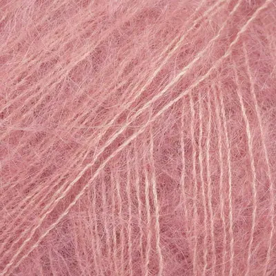 Close-up of pink yarn with fine beige threads.