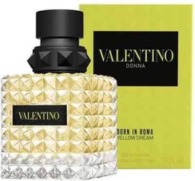 A bottle of Valentino Donna Born In Roma Yellow Dream Eau de Parfum for women and its packaging are displayed against a white background.
