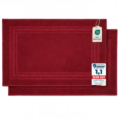 Two red bath mats are shown on a white background.