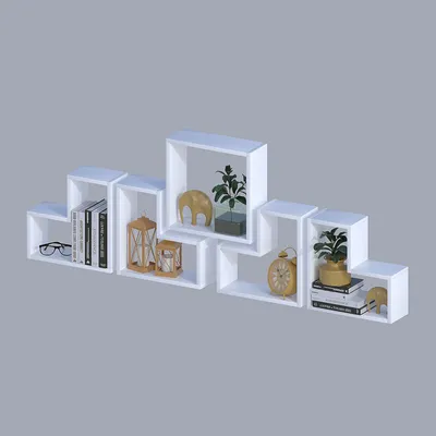 A set of white modular shelves arranged in a staggered pattern against a plain gray background.