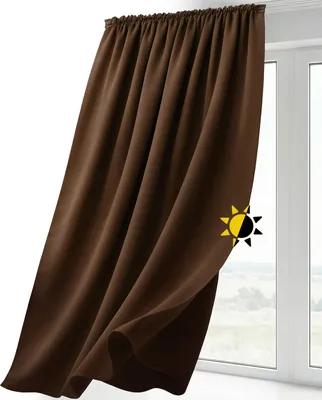 A brown curtain hanging in front of a window.