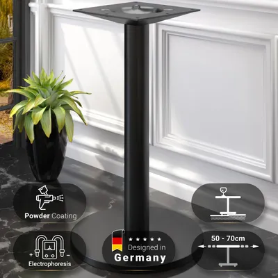 A black metal bistro table base with a round foot and a square top plate, placed on a marble-like surface next to a potted plant. Informational graphics are overlaid on the image.