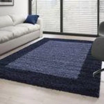 A living room scene with a sofa and a rug.