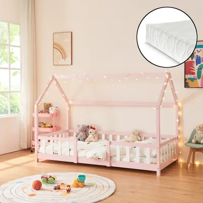 A child's bedroom with a pink house-shaped bed, toys, and decorative lights.