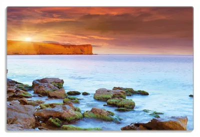Produktbild von Wallario Frühstücksbrettchen aus Glas 20 x 30 cm mit rutschfesten Füßen, Motiv Sonnenaufgang am Meer mit Landzunge und Felsen im Wasser