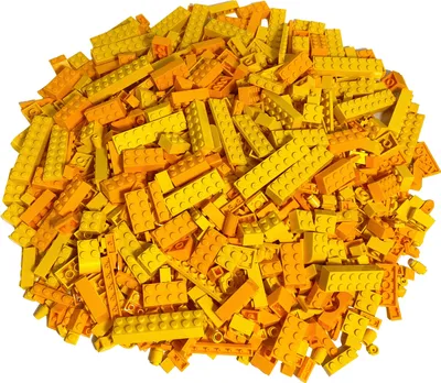 A pile of assorted LEGO bricks in yellow and orange hues.