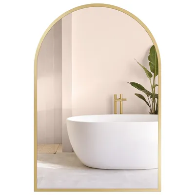 A bathroom scene reflected in an arched mirror.