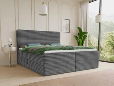 A bedroom scene with a bed, nightstand, and a large window with a view of trees.