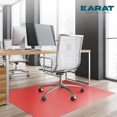 An office setting with desks, chairs, and computers, featuring a red floor mat.