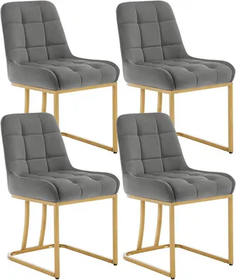 Four gray velvet dining chairs with gold metal frames arranged in a 2x2 grid against a white background.