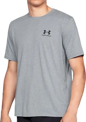 A person wearing a grey t-shirt with a black logo.