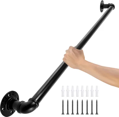 A hand is holding a black metal pipe handrail mounted on a white background. Screws and wall plugs are visible at the bottom right.