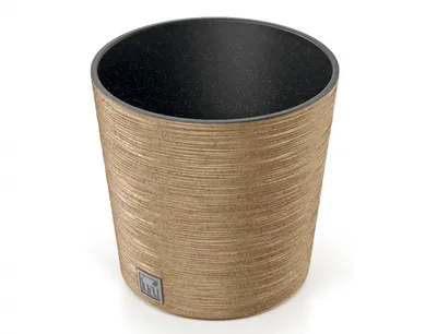 A close-up studio shot of a round, low planter pot with a textured wood-like exterior and a black interior.