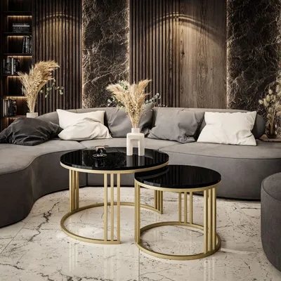 A modern living room with a curved sofa, coffee tables, and decorative elements.