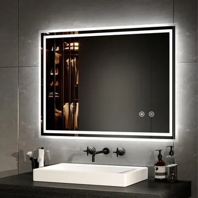 A modern bathroom vanity with a sink, faucet, and a large illuminated mirror.