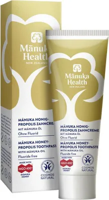A box and tube of Manuka Health toothpaste are shown against a white background.