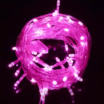 A coiled string of pink LED lights against a black background.