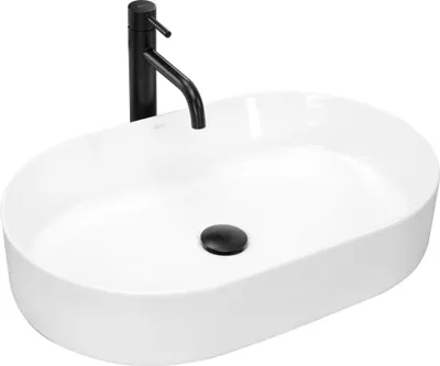 A white oval countertop sink with a black faucet and drain.