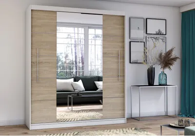 A modern bedroom or living room setting featuring a large sliding door wardrobe with mirrored panels.