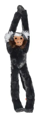 A stuffed monkey toy hanging by its arms.