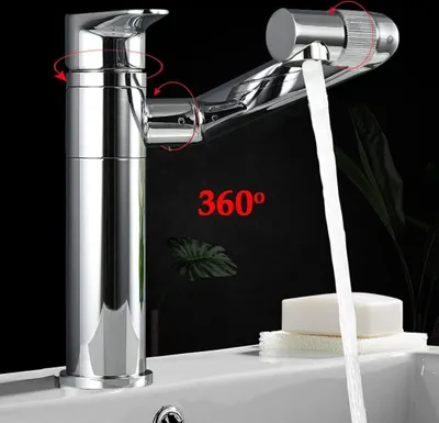 A chrome faucet with water flowing into a sink, with a bar of soap on a sponge nearby. The background is dark with some greenery.