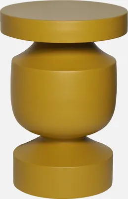 A mustard yellow side table with a rounded, hourglass-like shape.