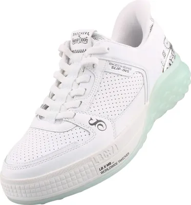 A white Skechers sneaker with a translucent green sole.