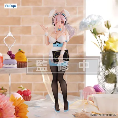 A figurine of Super Sonico dressed as a waitress, displayed on a table with pastries and flowers.