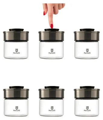 A hand is pressing the lid of one of six identical glass storage jars arranged in two rows.