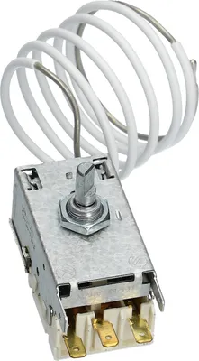A close-up view of a thermostat with a coiled wire attached.