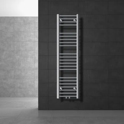 A modern bathroom with a chrome towel radiator mounted on a dark tiled wall.