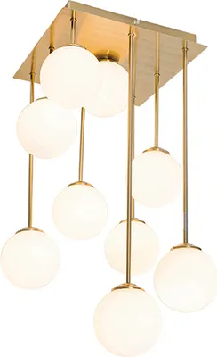 A modern gold chandelier with nine opal glass globes.