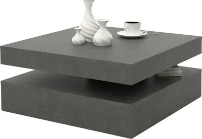 A modern, dark gray, two-tiered coffee table with decorative vases and a coffee cup on top.