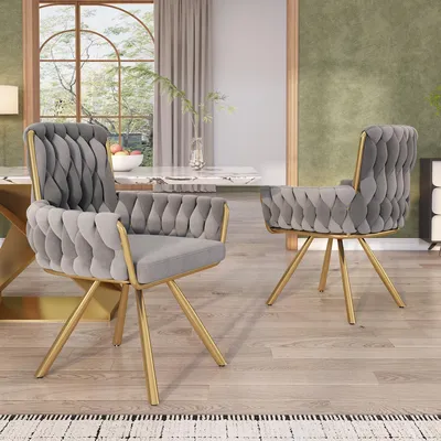 Two dining chairs in a dining room setting.