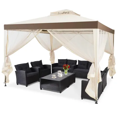 A patio gazebo with furniture set up inside.