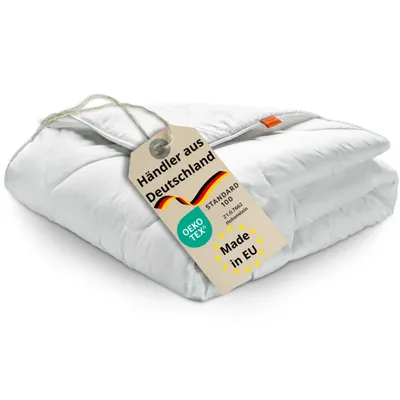 A folded white duvet with a tag attached.