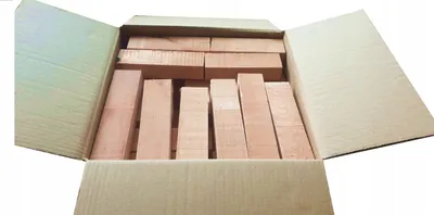 A cardboard box filled with wooden blocks.