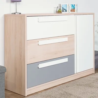 A modern dresser with a light wood frame, white drawers, and a gray drawer.