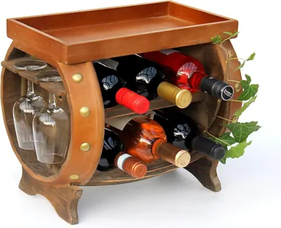 A wooden wine rack shaped like a barrel, holding several wine bottles and two wine glasses.