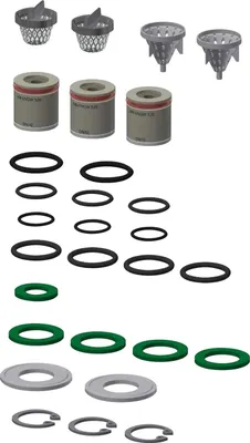 A collection of plumbing parts, including filters, O-rings, and seals, laid out on a white background.