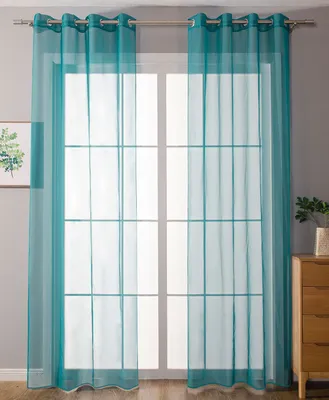 A room interior with a window covered by sheer turquoise curtains.