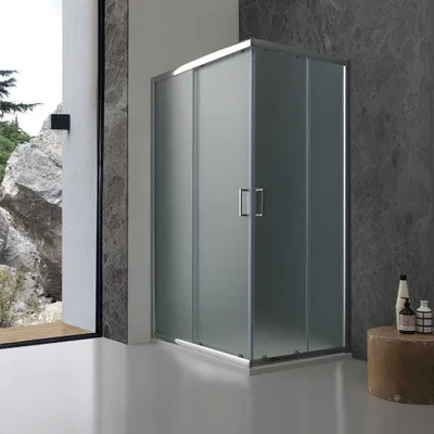 A modern bathroom with a frosted glass shower enclosure.