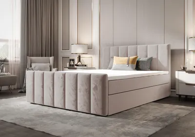 A bedroom scene featuring a large bed with a headboard and storage, bedside tables, and curtains.