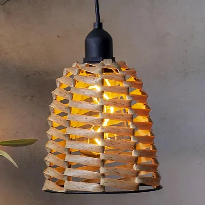 A close-up shot of a hanging lamp with a woven rattan-like shade.