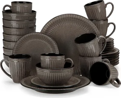 A collection of grey ceramic dinnerware, including plates, bowls, and mugs, neatly arranged.