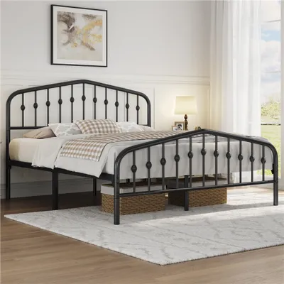 A black metal bed frame with a headboard and footboard, set up in a bedroom with bedding and a rug.