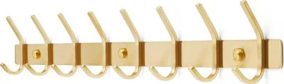 A brass-colored wall-mounted coat rack with eight hooks against a white background.