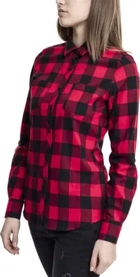 A woman is shown wearing a red and black checkered flannel shirt.