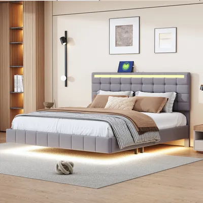 A modern bedroom with a grey upholstered bed featuring LED lighting.