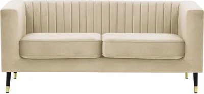 A studio shot of a beige sofa.